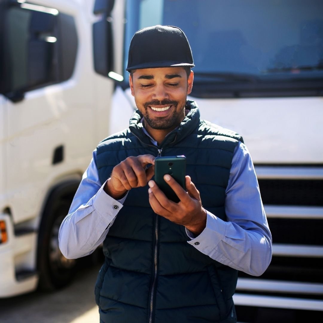 male-truck-driver-smiling-using-phone_adj_1080x1080