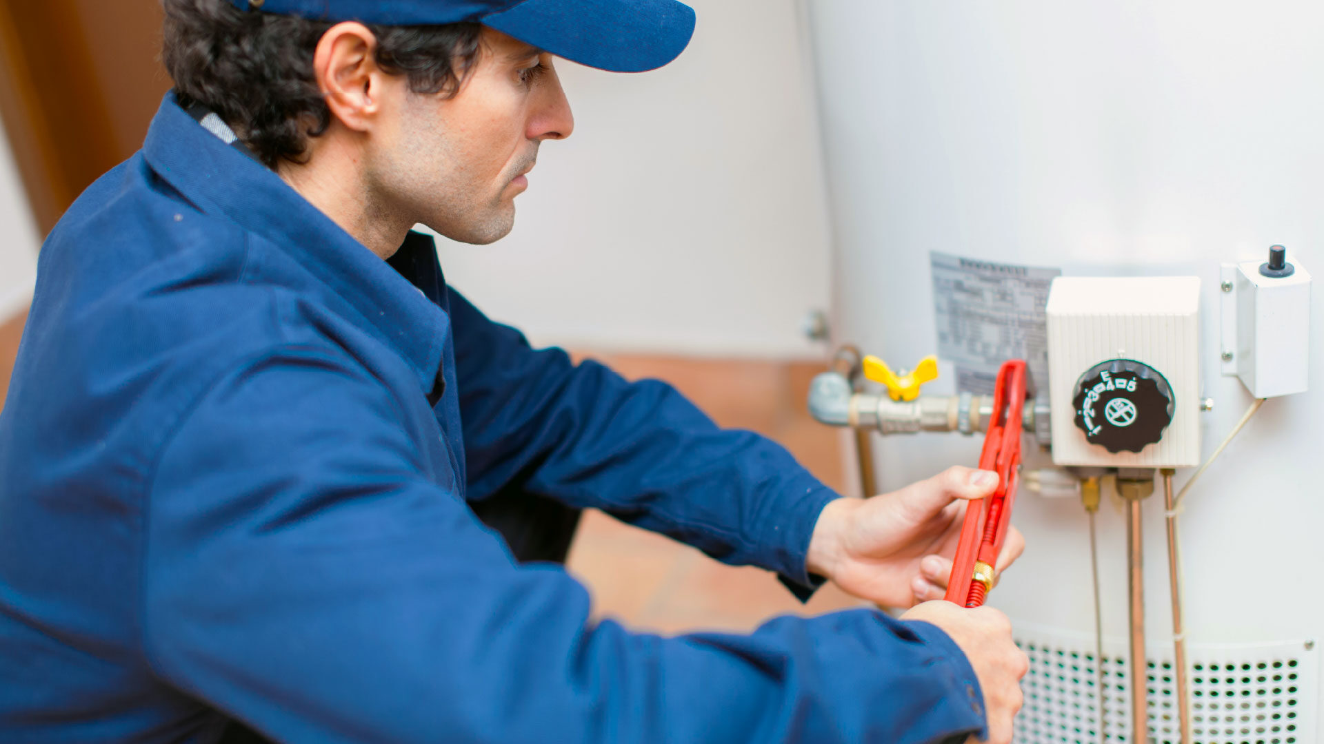 plumber-fixing-water-heater-2_adj_1920x1080